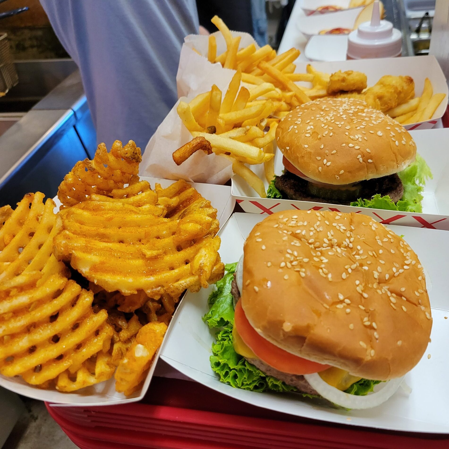 Order of burgers ready for pickup on a tray.